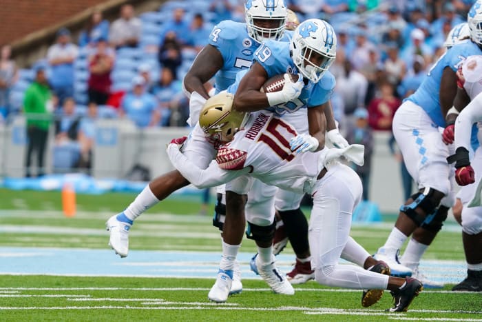 Florida State Seminoles defensive back Jammie Robinson (10) stops the run against North Carolina Tar Heels running back Ty Chandler (19) during the first half at Kenan Memorial Stadium. - James Guillory | USA TODAY Sports